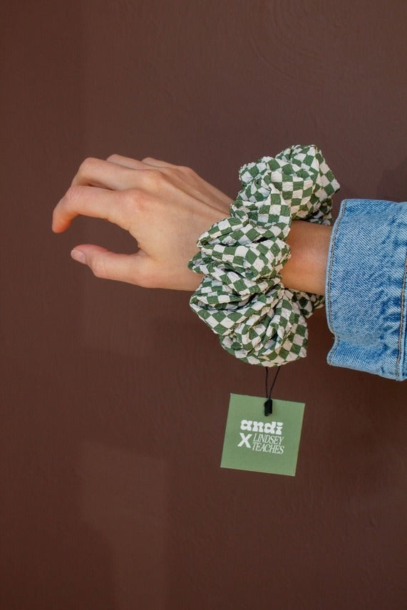 Close-up of the Lindsey Checked Jumbo Scrunchie displaying the green and white checkered pattern and textured crushed polyester fabric detail.