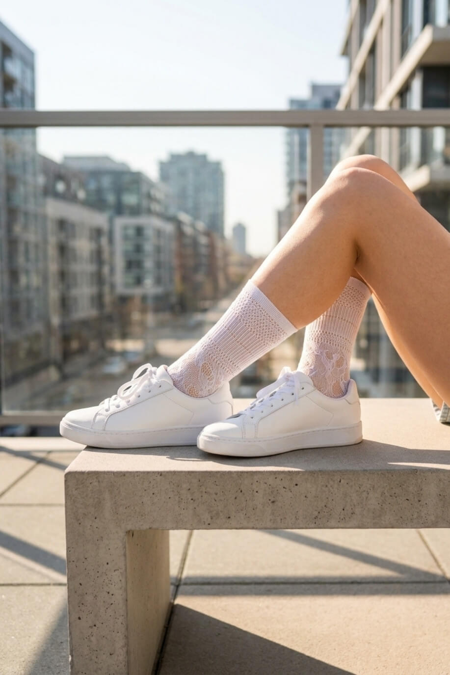 Sheer Floral Lace Crew Socks in white featuring a detailed floral lace design, styled with white sneakers on an outdoor balcony, showcasing the versatile, semi-transparent fabric and casual everyday styling.
