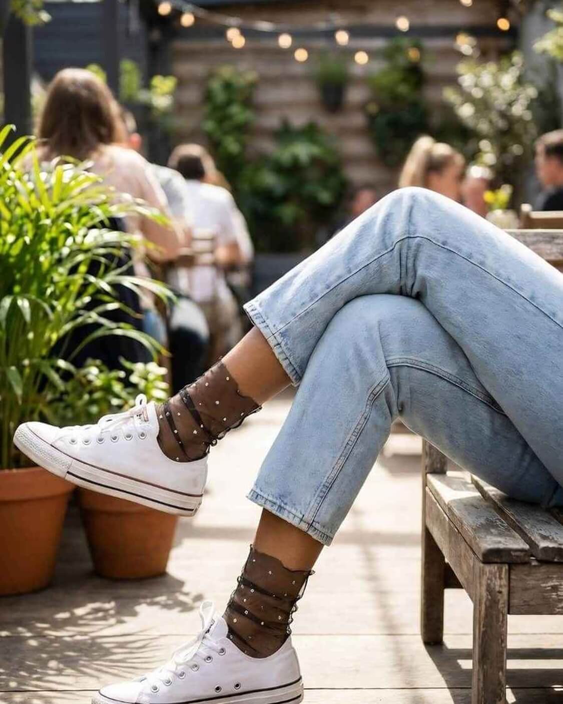 Star Soft Tulle Mesh Sheer Socks featuring lightweight sheer mesh construction with metallic star accents and relaxed ruching, paired with white canvas sneakers at an outdoor café, emphasizing breathable comfort and everyday streetwear styling.