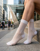 5-Pack Soft Horizon Sheer Socks featuring a sheer ribbed construction with reinforced heel and toe panels, worn while standing on city steps, highlighting a comfortable fit and breathable everyday wear.