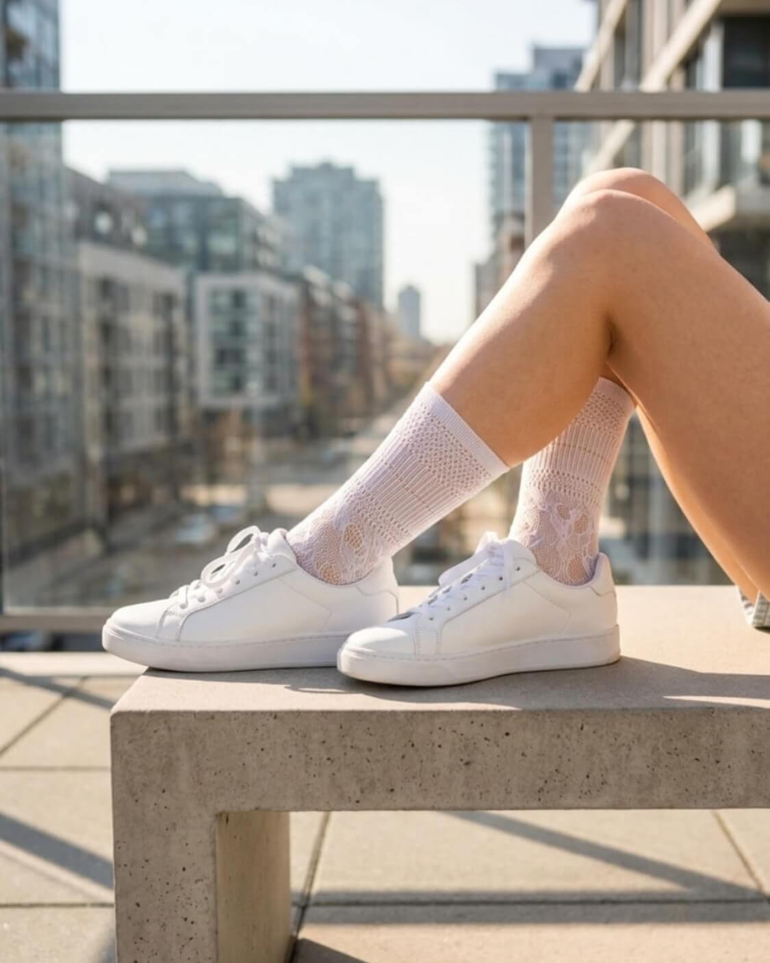 Sheer Floral Lace Crew Socks in white featuring a detailed floral lace design, styled with white sneakers on an outdoor balcony, showcasing the versatile, semi-transparent fabric and casual everyday styling.