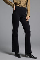 Model styled in black Kick Flare Pants Sasha Pants with leg-lengthening kick flare detail, tailored shape, and comfortable fit for office or casual wear.