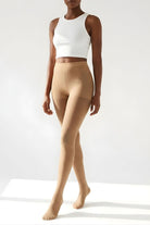 Lightweight Semi Opaque Tights in nude, featuring a natural-looking semi-opaque finish with a lightweight feel and high-rise waistband, shown full-length on a model in a neutral studio setting.