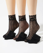 3-Pack Floral Diamond Lace Fishnet Socks featuring three unique black fishnet patterns with floral lace cuffs, displayed together on mannequin legs in a studio setting, highlighting the variety of openwork textures, elegant lace detailing, and versatile styling options for dresses, skirts, and casual footwear.