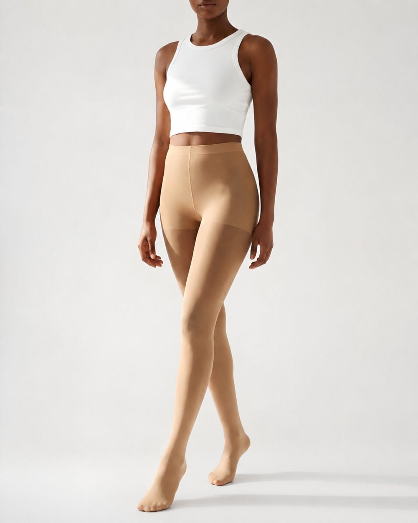 Lightweight Semi Opaque Tights in nude, featuring a natural-looking semi-opaque finish with a lightweight feel and high-rise waistband, shown full-length on a model in a neutral studio setting.