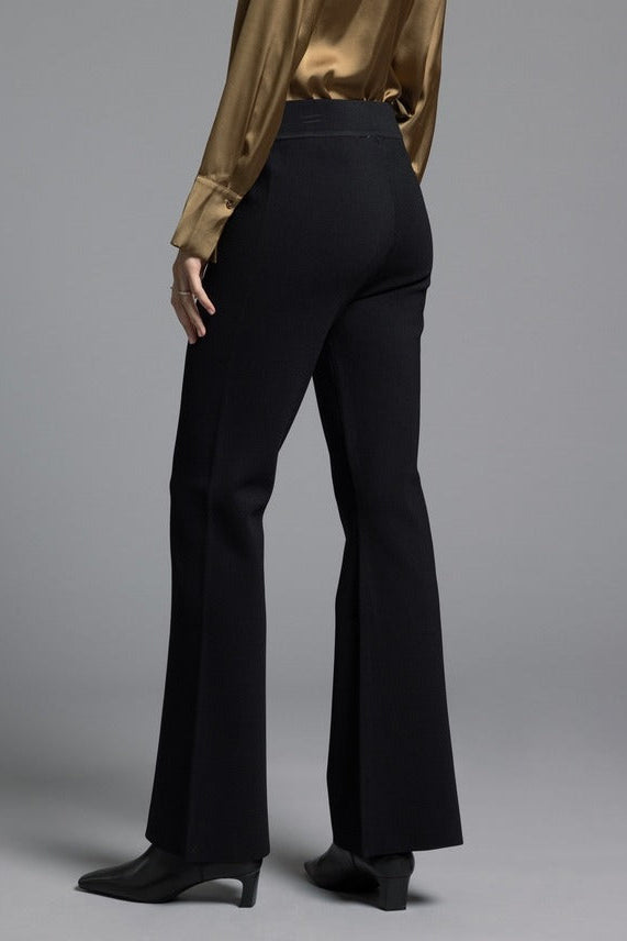 Model showcasing black Kick Flare Pants Sasha Pants designed with a fitted hip line, slight flare at the hem, and vintage-inspired silhouette.