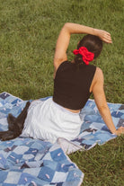 Model showcasing the Red Eyelet Jumbo Scrunchie in a styled hairstyle, highlighting the bold red color and oversized gathered shape.