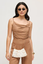 Model wearing an iridescent opalite evening bag with a luminous, color-shifting finish, compact elegant design, and celestial shimmer, ideal for weddings, galas, formal events, and sophisticated date night looks.