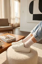 Lace Pattern Sheer Sock featuring sheer white lace pattern socks worn on crossed legs against a neutral studio background, highlighting delicate knit texture, flexible fit, and breathable everyday comfort.