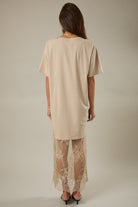 Back view of model wearing the taupe Round Neck Lace Joined T-Shirt Maxi Dress highlighting the flowing maxi skirt and lace panel detailing.