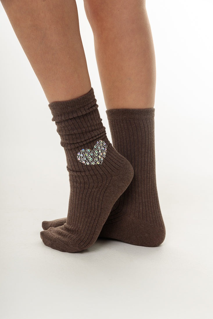 Brown ribbed socks with a heart-shaped embellishment on a white background