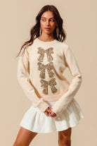 Young model wearing the Sequin Bow Embellished Sweater.