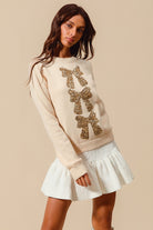 Young model wearing the Sequin Bow Embellished Sweater 6.
