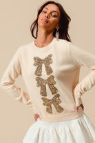 Young model wearing the Sequin Bow Embellished Sweater 7.