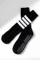 Knee High Yoga Socks featuring a soft knit construction with durable non-slip grip pattern on the soles and bold stripe detail at the top, displayed flat on a clean background, showcasing design and functional features.