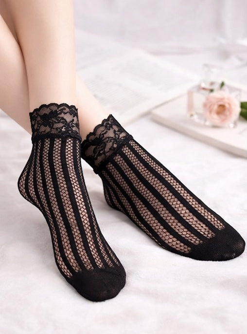 Black vertical stripe mesh ankle socks with floral lace cuffs, worn on a model against a soft white background.