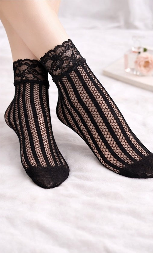 Black vertical stripe mesh ankle socks with floral lace cuffs, worn on a model against a soft white background.