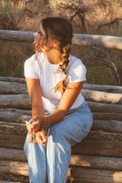 Model wearing the Chestnut Bow Scrunchie in a centipede braid hairstyle featuring a soft brown tone and decorative bow detail for added charm.