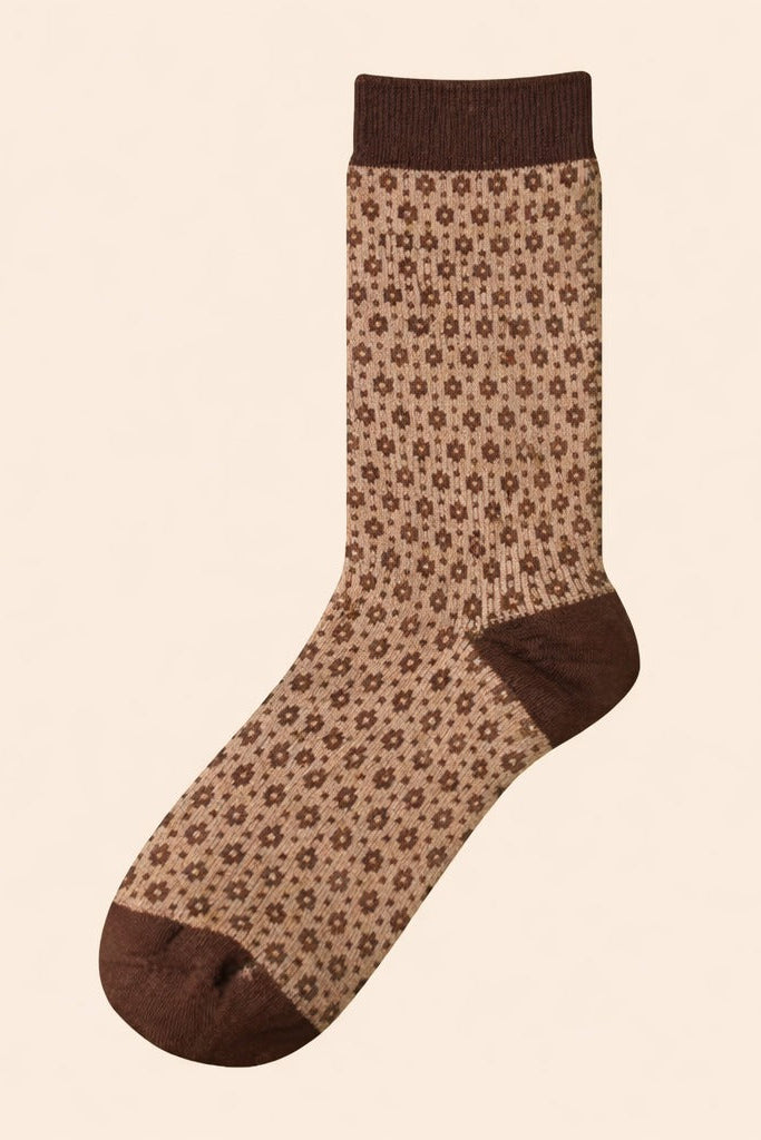 Neutral brown crew sock with vintage micro floral pattern and contrasting cuff, heel, and toe on a beige background.
