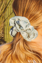 Close-up of the Eucalyptus Jumbo Scrunchie showcasing the smooth sateen fabric, matte finish, and light blue green eucalyptus color.