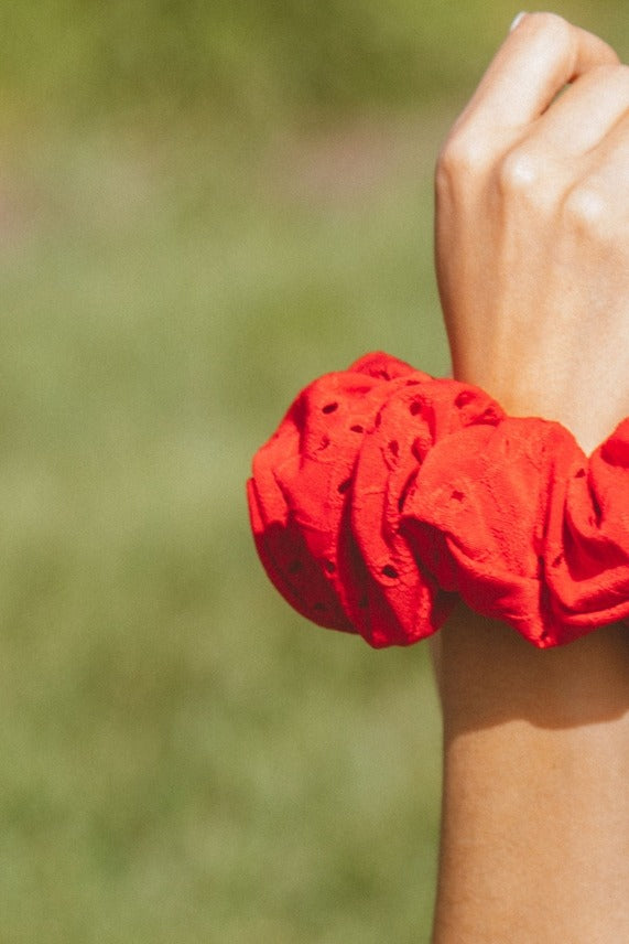 Detailed close-up of the Red Eyelet Jumbo Scrunchie highlighting the breathable eyelet material and full gathered design.