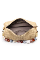 Interior view of the natural Rachel Straw Clutch displaying a neatly sized compartment that fits a phone, cards, and daily must-haves.