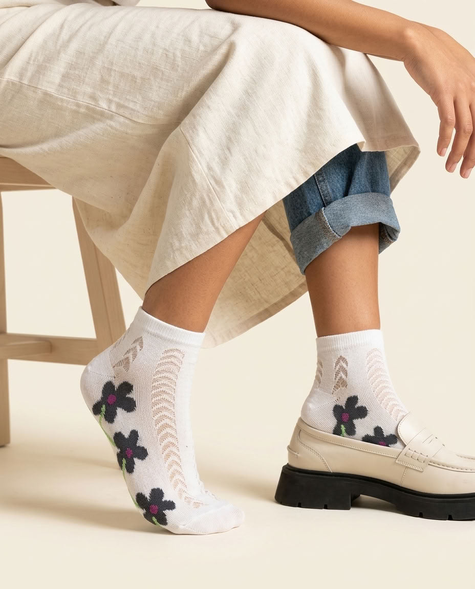 White daisy pointelle low-cut socks with dark floral print styled with a cream loafer