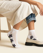 White daisy pointelle low-cut socks with dark floral print styled with a cream loafer
