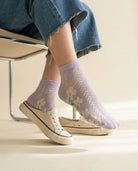 Lavender daisy pointelle low-cut socks worn with white canvas sneakers