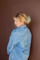Model showcasing the Lindsey Checked Jumbo Scrunchie styled in a hairstyle, featuring a jumbo silhouette and festive green and white checked design.