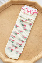 Sheer mesh crew socks with a pink tulips pattern and a soft lettuce-edge cuff on a neutral background.