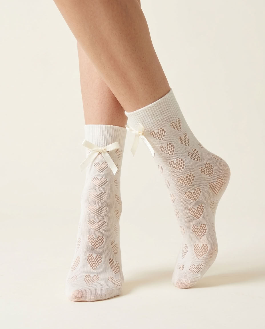 Milk White Heart-Shaped Lace Bow Socks, close-up showing open-knit hearts and cream satin bows